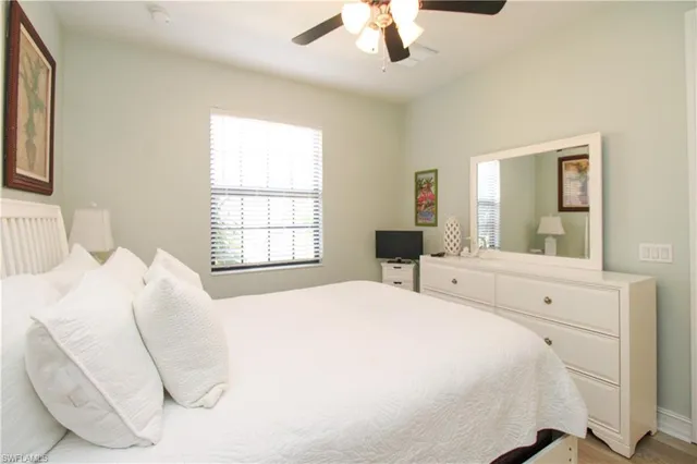 a spacious bedroom with a bed and a large mirror