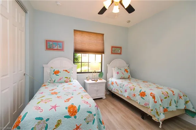 a bedroom with two beds and a chandelier