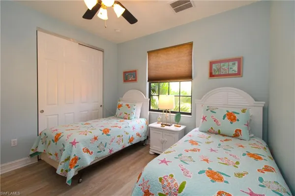 a bedroom with two beds and a window