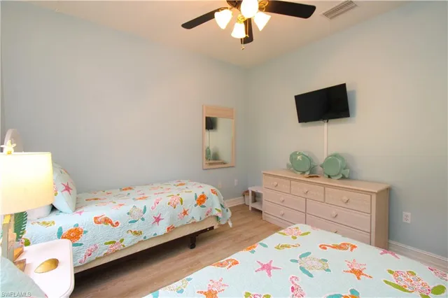 a bedroom with a bed and a dresser in it