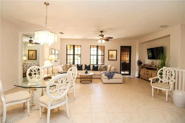 a living room with furniture chandelier and a view of kitchen