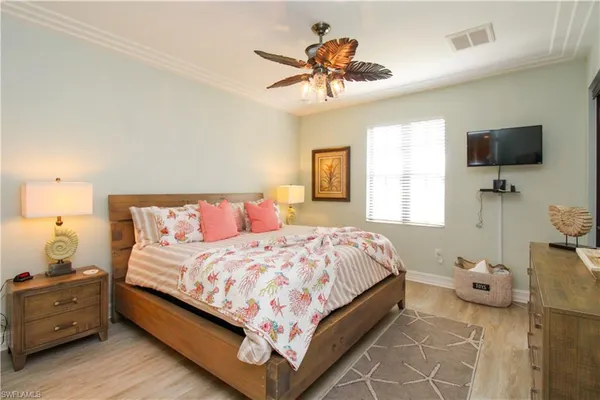 a bedroom with a bed and flat screen tv