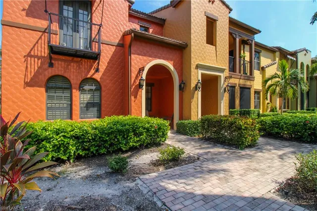 front view of a brick house with a small yard
