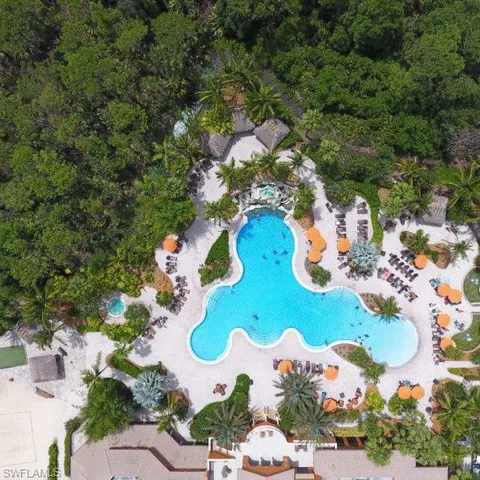 an aerial view of a house with a yard and outdoor seating
