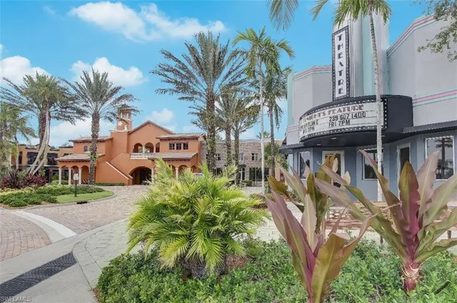 a front view of a multi story building with yard