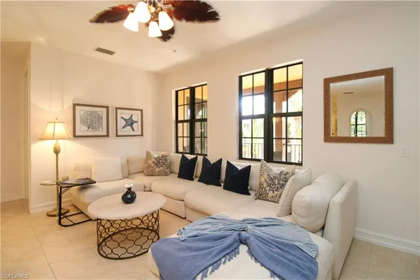 a living room with furniture and a large window