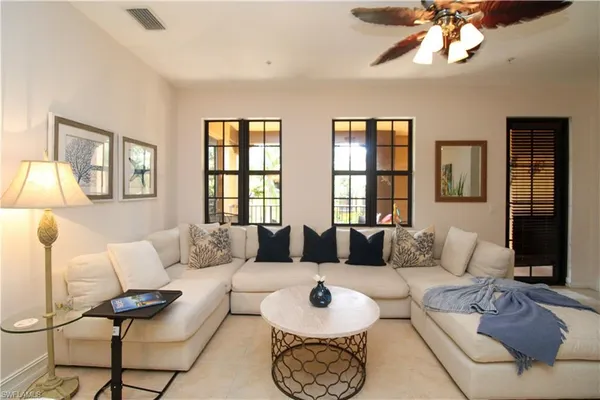 a living room with furniture and a large window