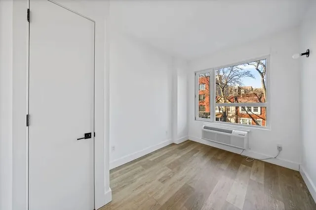 a kitchen with a sink a refrigerator and cabinets