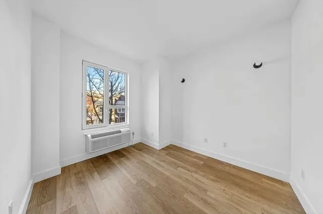 a view of room with window and hardwood floor