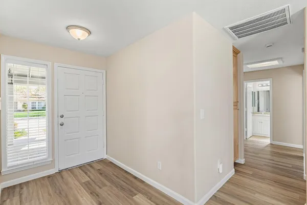 a view of hallway with wooden floor