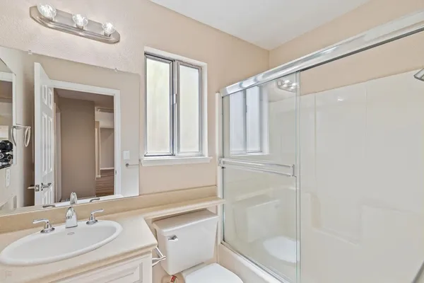 a bathroom with a sink toilet and shower