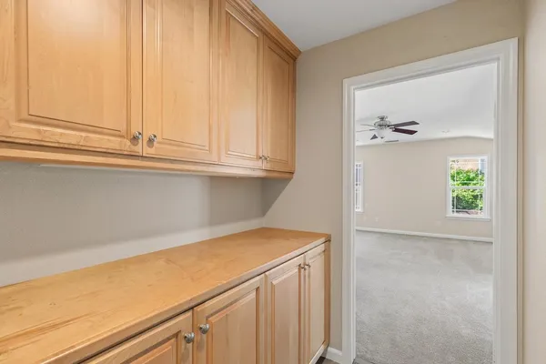 a view of kitchen cabinets and window