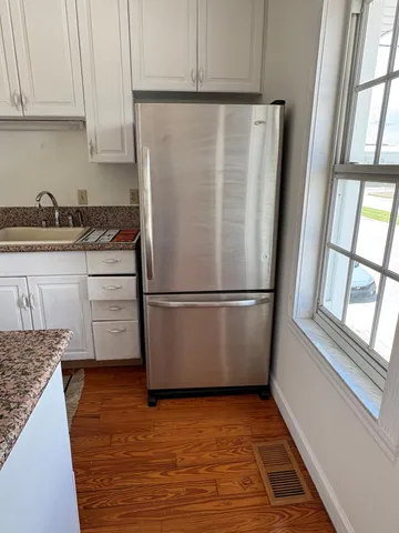 a white refrigerator freezer sitting inside of a kitchen