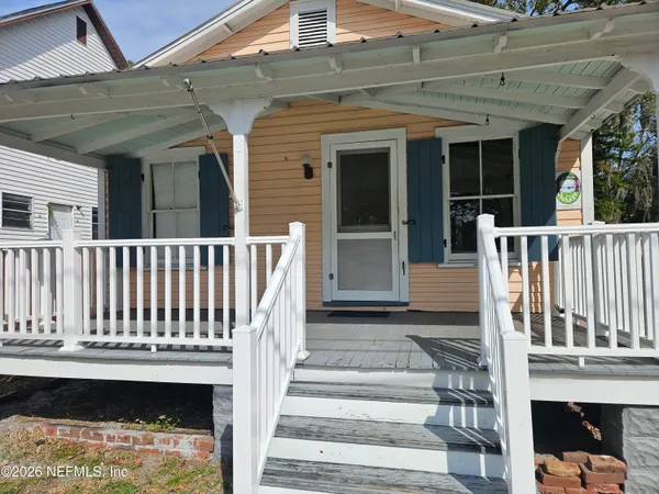 a view of small house with wooden floor and a floor to ceiling window