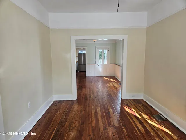 a view of hallway with wooden floor