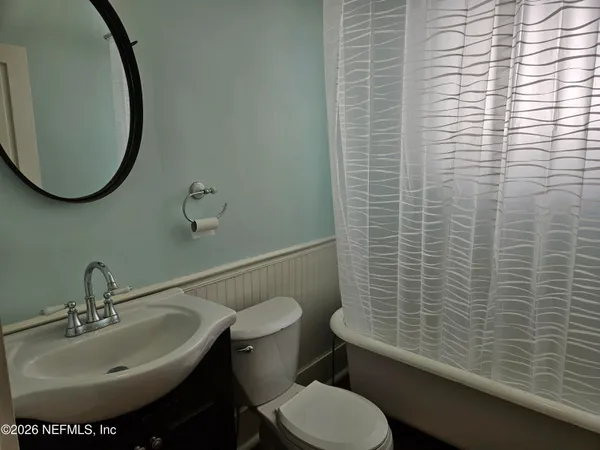 a bathroom with a sink toilet and a mirror