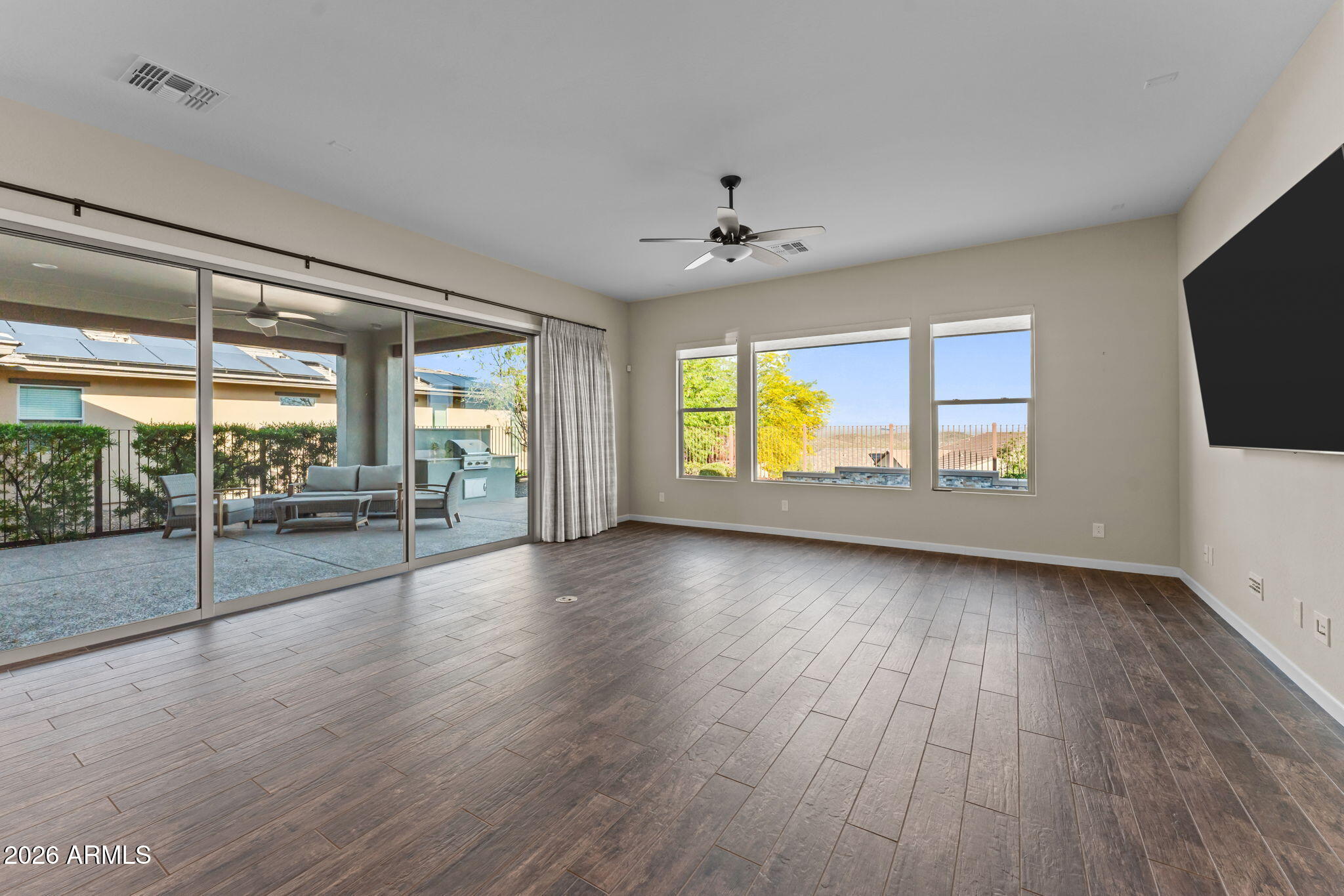 3675 Gold Ridge Road Wickenburg, AZ 85390 - Photo 17 of 58 a view of an empty room with a window and wooden floor