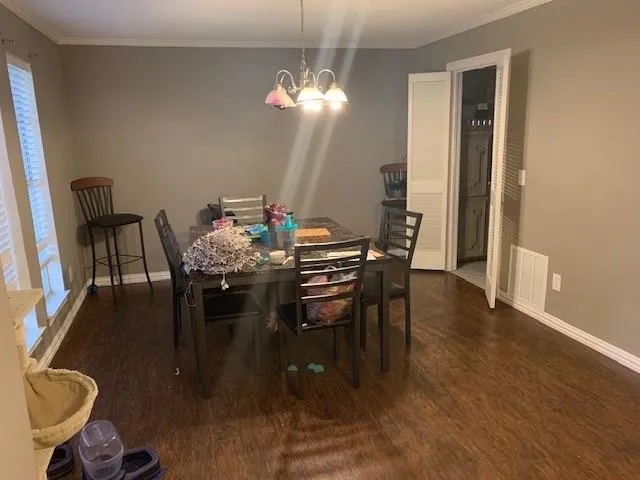 a dining room with furniture and wooden floor