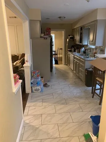 a kitchen with refrigerator and cabinets