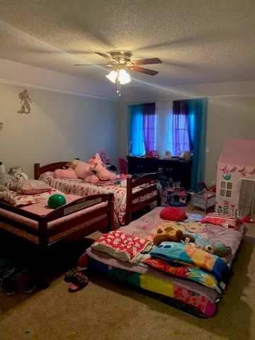 a bedroom with bed and window