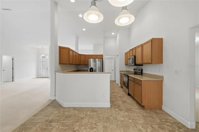 a large kitchen with cabinets and stainless steel appliances