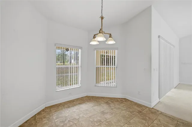 a view of an empty room with windows