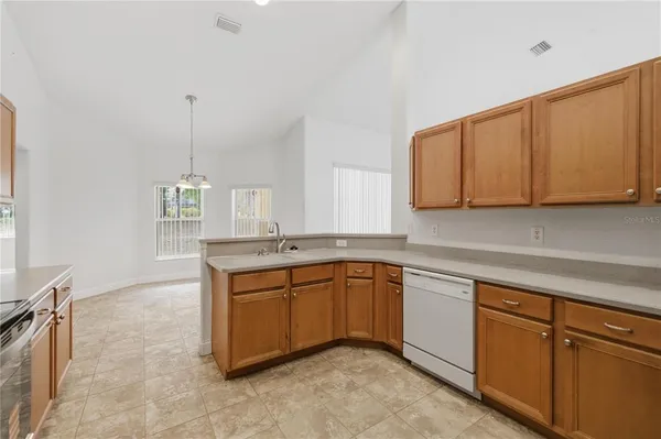 a kitchen with sink cabinets and window
