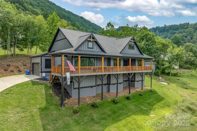 a view of a house with a yard and sitting area
