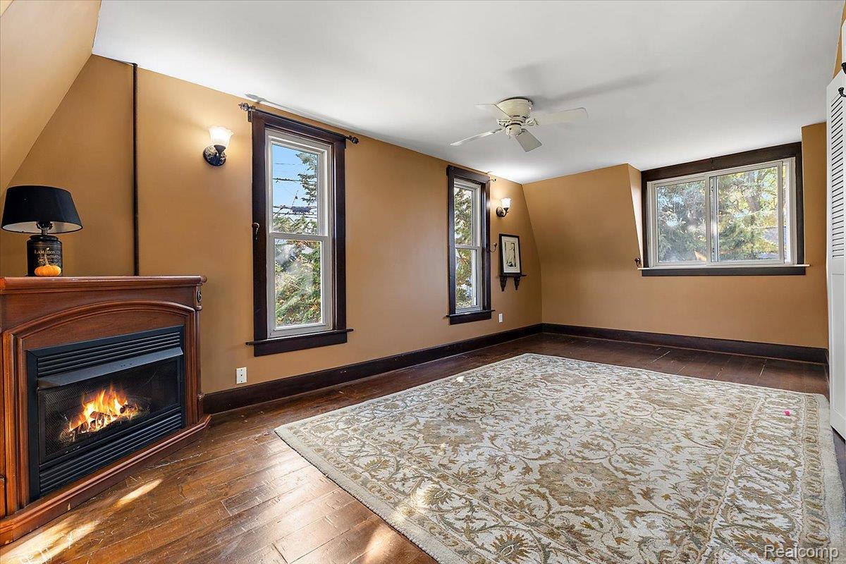 5815 Chicago Road Warren, MI 48092 - Photo 31 of 47 Home theater with dark wood-style floors, plenty of natural light, and a glass covered fireplace