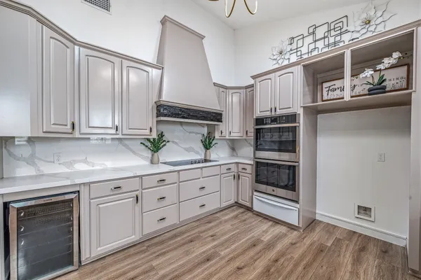 a kitchen with granite countertop white cabinets and white appliances
