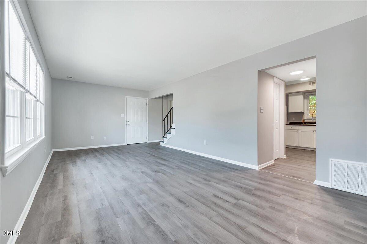 3408 Atlantic Avenue Raleigh, NC 27604 - Photo 25 of 48 wooden floor in an empty room with a window