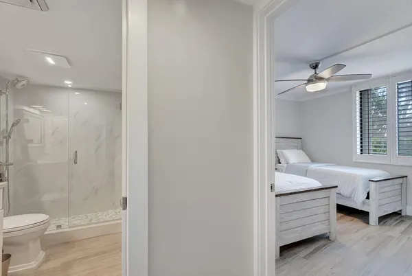 a bathroom with a white tub shower vanity and a sink