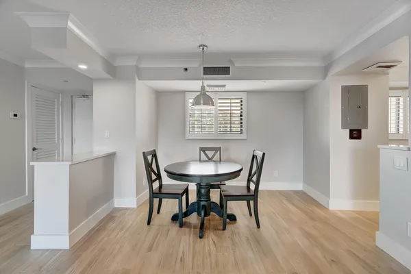 a view of a dining room with furniture window and wooden floor