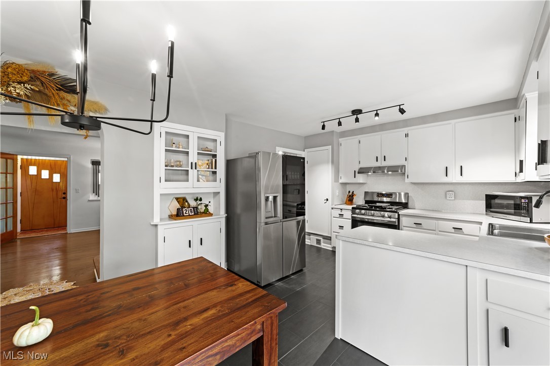 4648 Ammon Road Cleveland, OH 44143 - Photo 8 of 48 Kitchen featuring white cabinetry, stainless steel appliances,