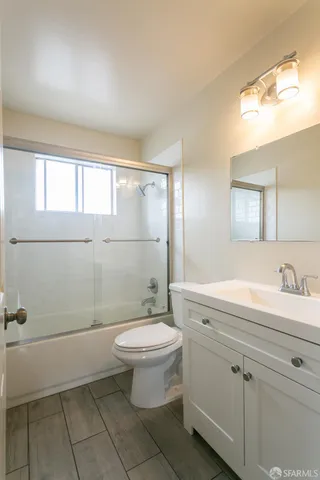 a bathroom with a sink a toilet and mirror