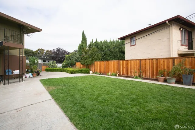 a view of backyard with outdoor seating and trampoline