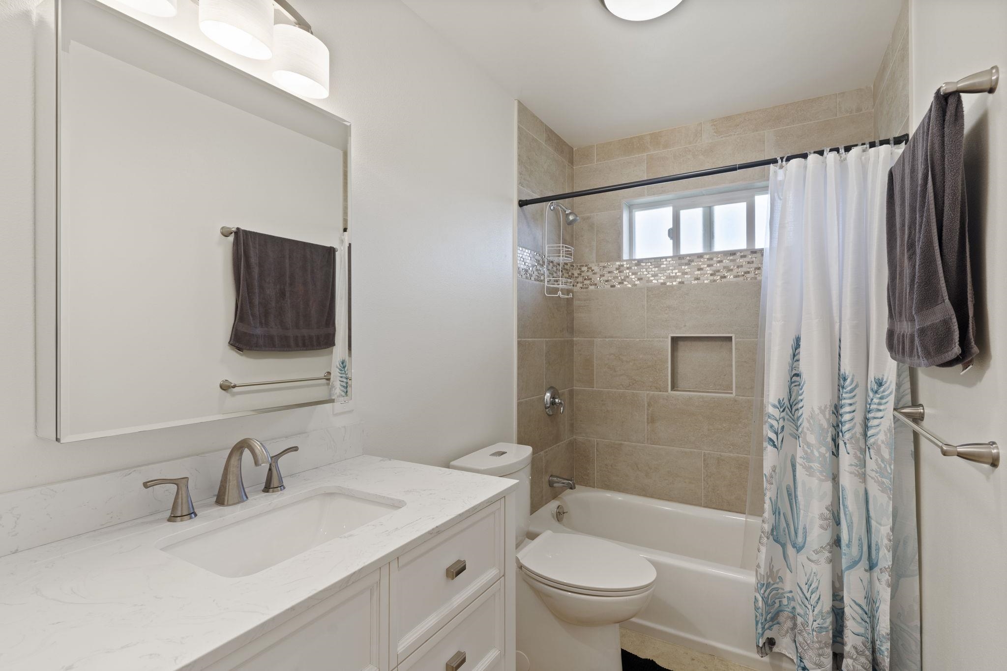 752 Awalau Road, Unit B Haiku, HI 96708 - Photo 26 of 30 a bathroom with a granite countertop sink toilet and shower