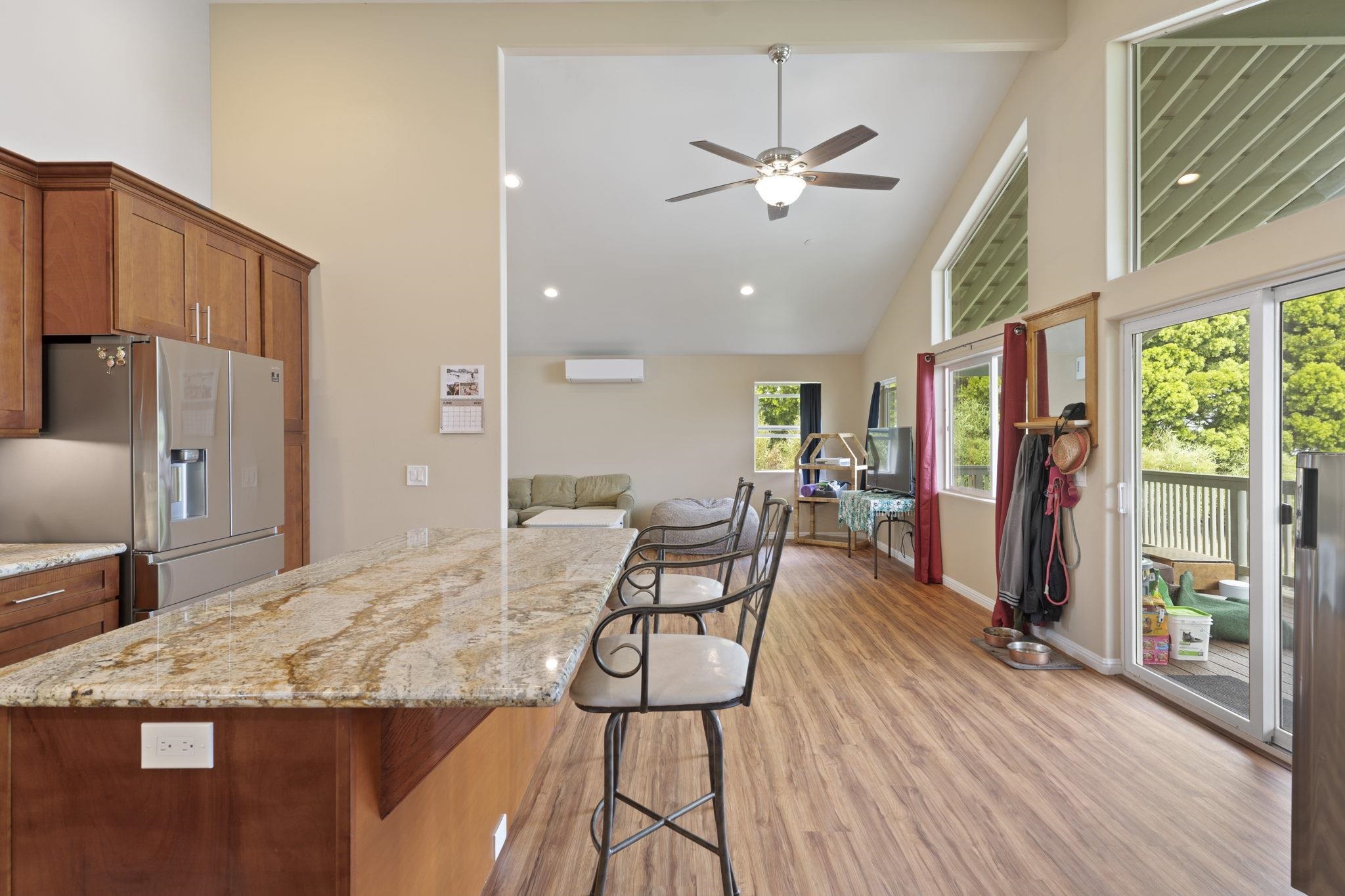 752 Awalau Road, Unit B Haiku, HI 96708 - Photo 8 of 30 a view of a dining room with furniture window and wooden floor