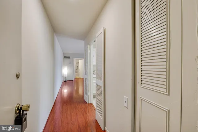 a view of a hallway with wooden floor