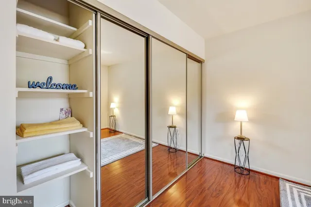 a view of empty room with wooden floor