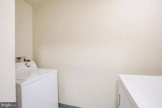 a view of kitchen with refrigerator cabinets and wooden floor