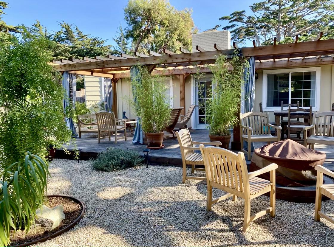 26208 Atherton Drive Carmel, CA 93923 - Photo 14 of 22 a view of a patio with table and chairs potted plants and floor to ceiling window