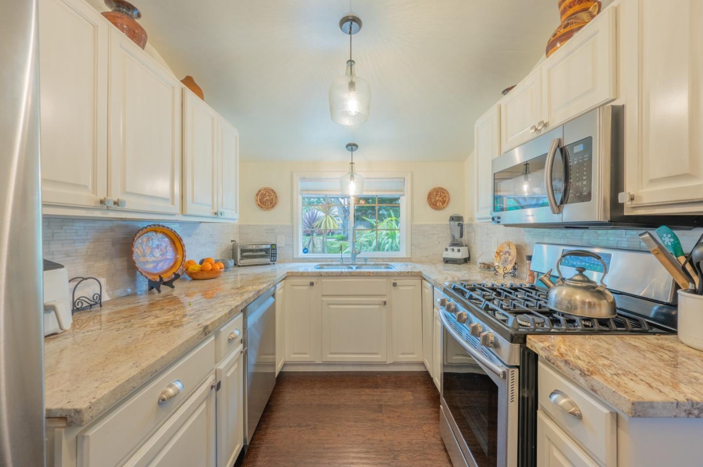 26208 Atherton Drive Carmel, CA 93923 - Photo 5 of 22 a kitchen with a sink stove top oven and cabinets