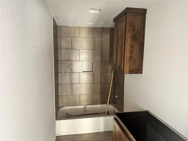 a bathroom with a bathtub and shower