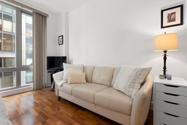 a living room with couches and a flat screen tv