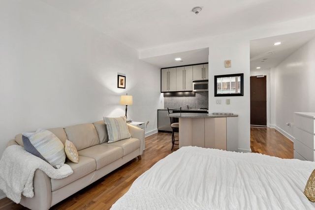 a living room with kitchen island furniture and a kitchen view
