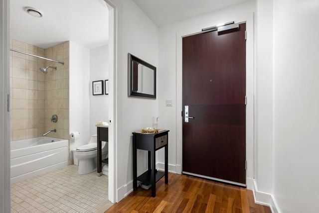 a bathroom with a bathtub a toilet and a shower