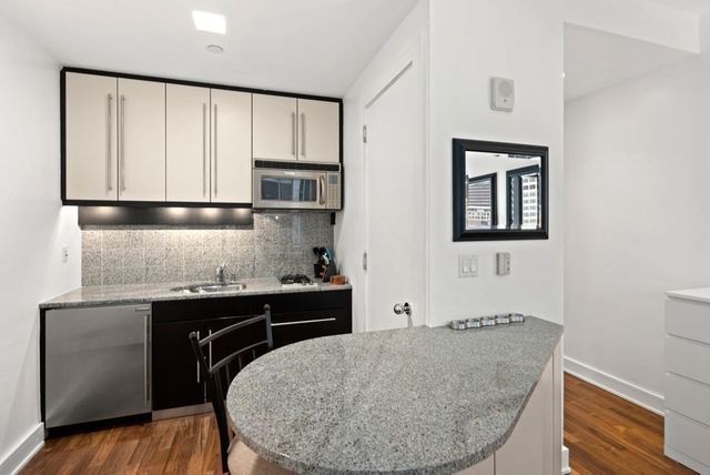 a kitchen with a sink cabinets and window