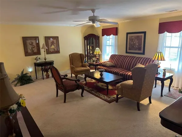 a view of a dining room with furniture and chandelier