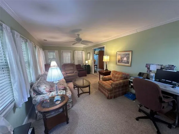 a living room with furniture and a floor to ceiling window